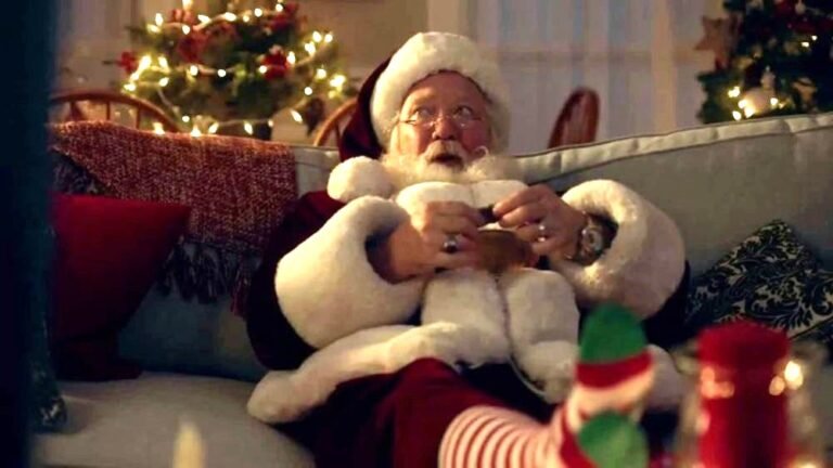 SANTA CLAUS ENOYING A KIT KAT